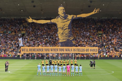 A tifo mural is unfurled as a minute's applause is observed in memory of the late Diogo Jota.