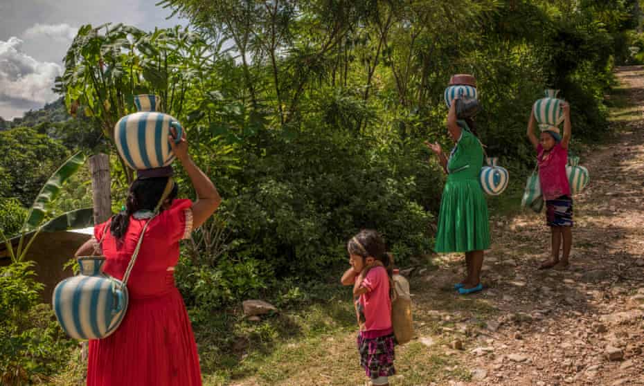 Women of Guaiabo village carry water to their houses. Guatemala has contributed very little to greenhouse gas emissions but its people are suffering acutely from their impact.