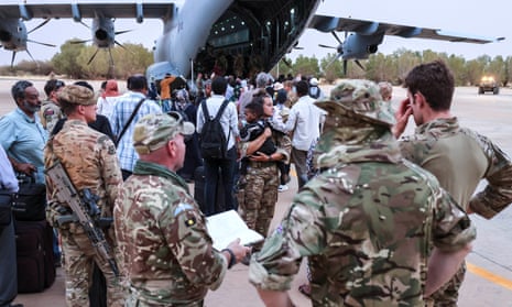 British nationals wait to board an RAF aircraft, during the evacuation to Cyprus, at Wadi Seidna airbase in Sudan.