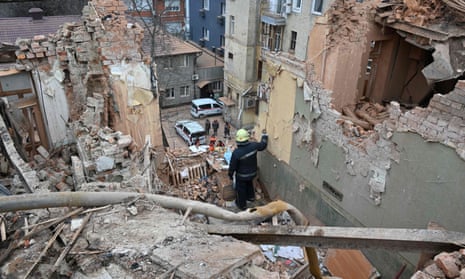 Ukrainian rescuers clear the debris of the residential building.