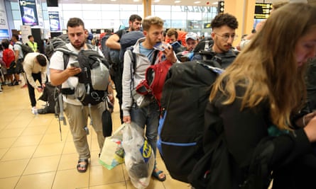 Young Israelis queue to board a flight to Tel Aviv in Lima, Peru, the day after the country announced the drafting of 300,000 reservists.