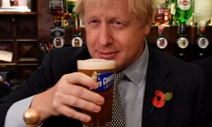Boris Johnson holds a pint