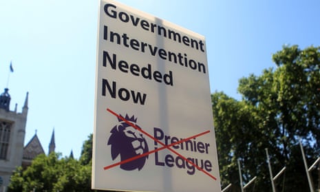 A banner is seen at Parliament Square calling for the Government to intervene at football clubs