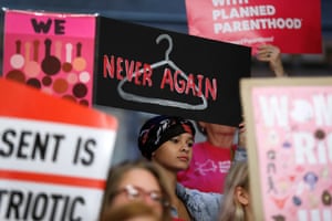 August Mulvihill, of Norwalk, Iowa, holds a sign during a rally to protest recent abortion bans, on 21 May 2019, at the statehouse in Des Moines, Iowa.