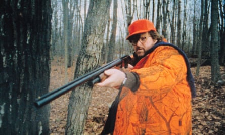 Michael Moore holding a rifle.