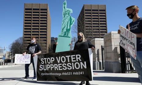 Demonstrators attend a protest against voter restriction laws outside the Georgia state capitol.