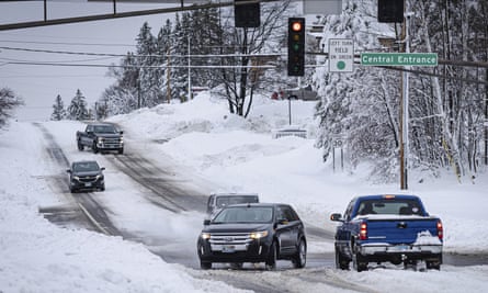 Cars slowly travel through an intersection after a second round of snow storm passed through northern Minnesota Thursday, Dec. 15, 2022, in Duluth, Minn. (AP Photo/Holden Law)