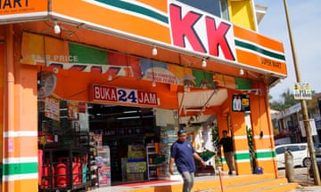 A customer walk out from KK Mart convenience store in Puchong area on the outskirts of of Kuala Lumpur