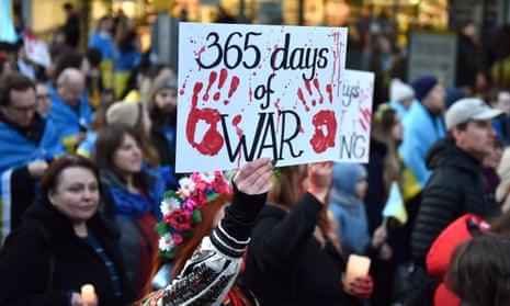 A protester holds up a placard during a march from Holland Park to the Russian embassy in London.