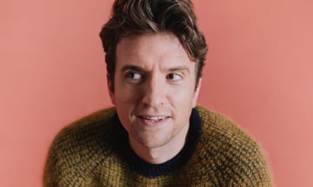 Greg James against a pink background.