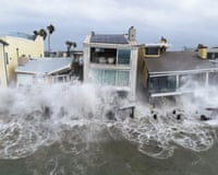 Storm waves crash into the boardwalk and homes in Long Beach, California, 11 October
