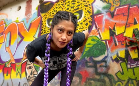 Cat Monzón in front of a colourful mural.