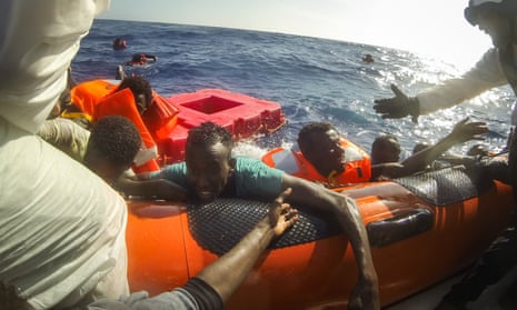 Migrants are pulled aboard a rescue craft after a boat carrying more than 500 people capsized off Lampedusa last week.