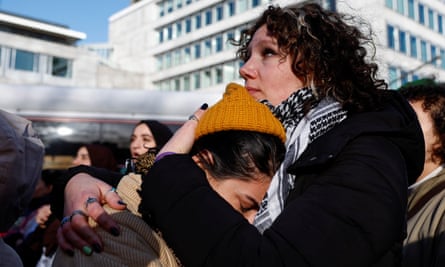 Two Pro-Palestinian demonstrators embrace