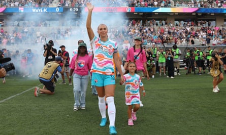 Alex Morgan entered the field alongside her daughter, Charlie