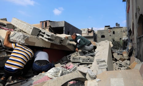 People search for survivors among rubble of a building after it was destroyed during an Israeli air strike in the southern Gaza Strip city of Khan Younis