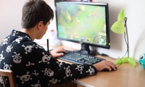 Boy playing video game on PC