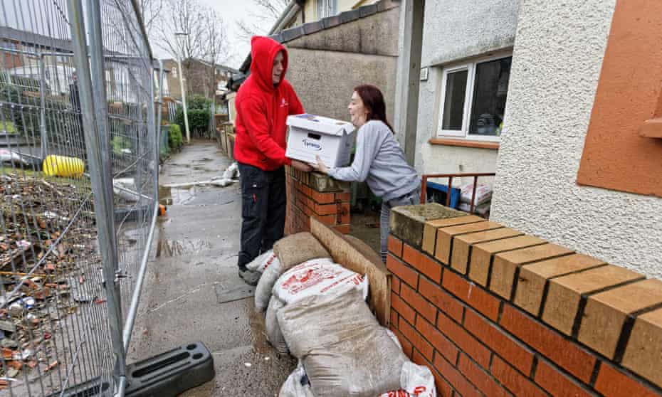 Joanne Mardon receives a food bank delivery outside her flood-affected home in the Rhydyfelin area of Pontypridd