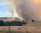 WA bushfire downgraded while Queensland and NT brace for monsoonal rain and flooding
