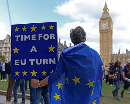A man holds a sign outside Westminster reading ‘Time for a EU turn’.