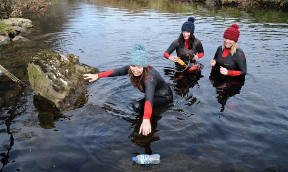 Surfers Against Sewage representatives collecting litter in the Afon Glaslyn in Snowdonia.