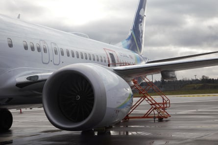 wide view of side of plane, with red markings around area where piece came off