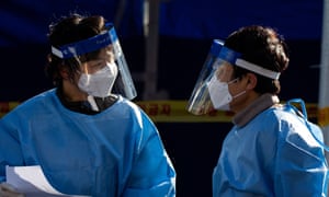 Medical professionals work at a makeshift coronavirus testing clinic at Seoul Station in Seoul, South Korea.