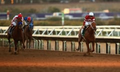 Gun Runner, right, ridden by Florent Geroux, defeats Collected, left.