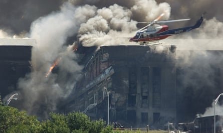 A rescue helicopter surveying damage to the Pentagon after a hijacked plane crashed into during the 9/11 terrorist attack in 2001.