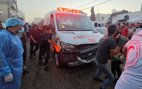Palestinians pull a damaged ambulance after a convoy of ambulances was reportedly hit.