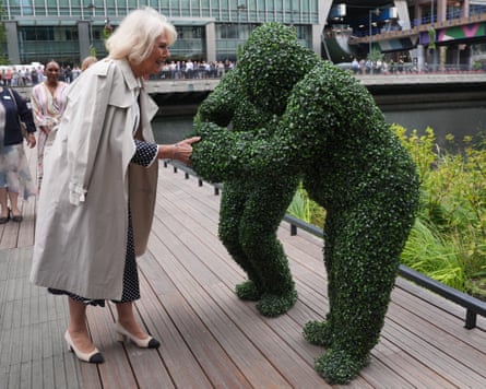 Camilla talks to a human dressed as a hedge