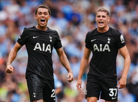 Tottenham Hotspur's Brennan Johnson (left) celebrates alongside Micky van de Ven after scoring their side's first goal of the game at Manchester City.
