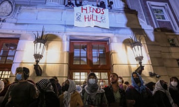 Protesters link arms outside Hamilton Hall, barricading students inside the building at Columbia University, New York