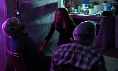 Maggie Q looks at two men who are tied to chairs with bags over their heads in Fear the Night