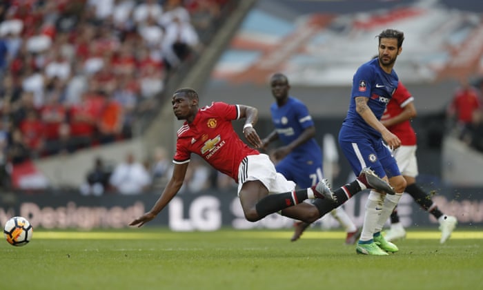 Paul Pogba goes down under a challenge from Cesc Fabregas.