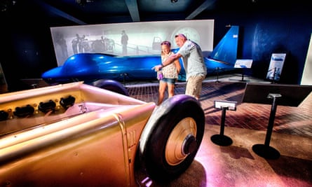 A father and daughter look at land-record-speed breaking cars at the National Motor Museum, Beaulieu, Hampshire, UK>