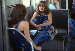 a Willy Spiller photo titled "Best Friend, 1983" - two young women both in blue denim dungarees sit opposite each other on a subway train talking