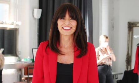 Davina McCall in a red jacket and black top, smiling