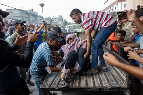 Palestinians transport injured people to the Nasser hospital after an Israeli bombing east of the Khan Younis camp in the southern Gaza Strip.