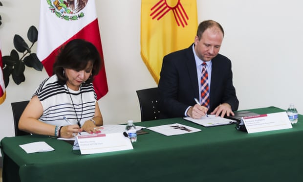 Norma Ang Sanchez and Andrew Rodgers sign the paperwork to return the items.
