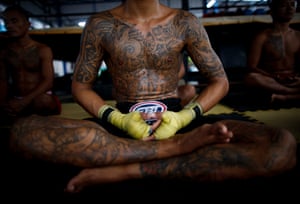 Thai inmates practice meditation as part of a Muay Thai boxing rehabilitation programme at Nonthaburi prison, Thailand.