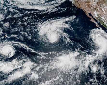 This satellite image shows three storms, from left, Hurricane Lowell, Hurricane Karina and Tropical Storm Marie in the Pacific Ocean.