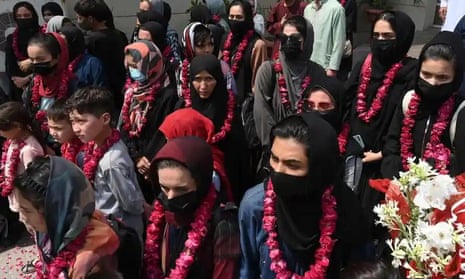 Members of the football team and their families are greeted in Pakistan after fleeing Afghanistan
