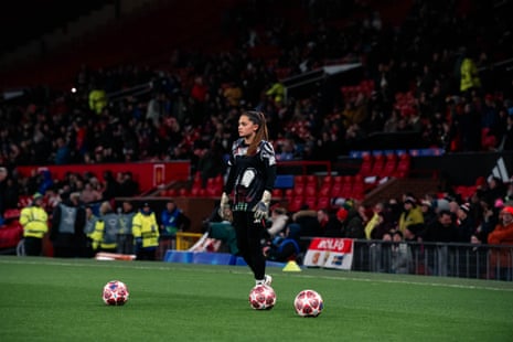 Safia Middleton-Patel of Manchester United stands on the Old Trafford grass with three footballs around her.