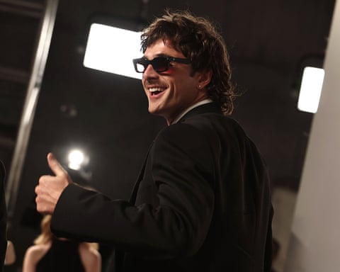 Jacob Elordi smiling over his shoulder at Vanity Fair Oscar party