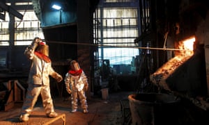 Workers monitor a process inside a plant at the copper smelter of Codelco Ventanas in Ventanas city, Chile.