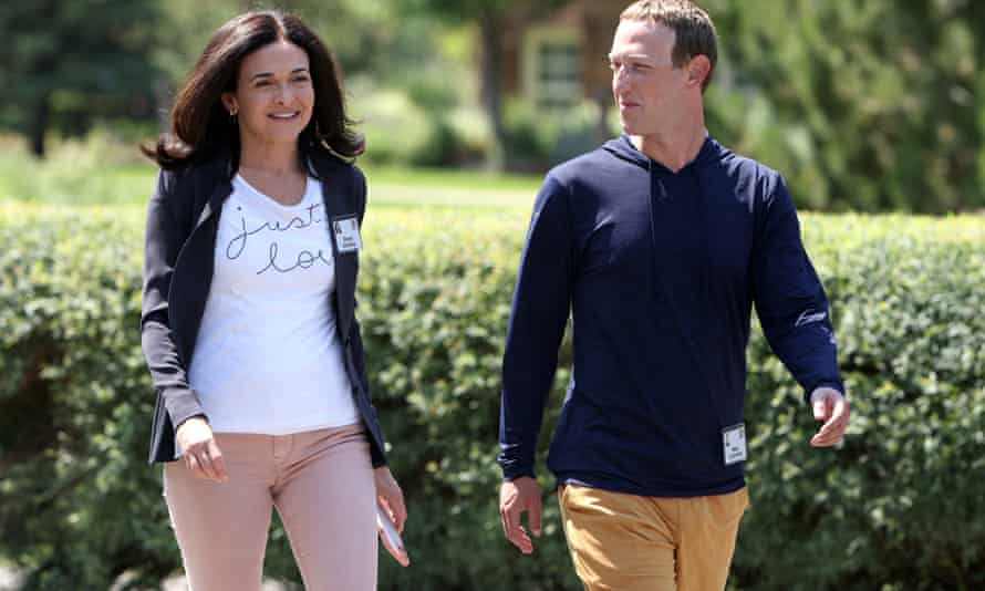 Mark Zuckerberg walks with Sheryl Sandberg.