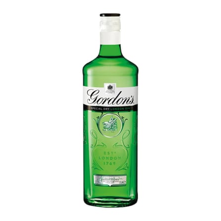 A green glass bottle of Gordon’s gin with a white top and embossed detail. The word Gordon’s is on a white label near the top of the bottle.