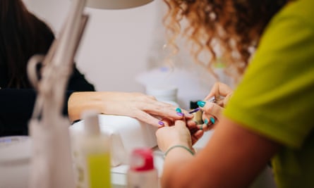 Manicurist doing someone’s nails