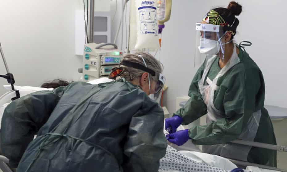 Nurses care for a patient in an intensive care ward in Frimley Park hospital in Surrey.